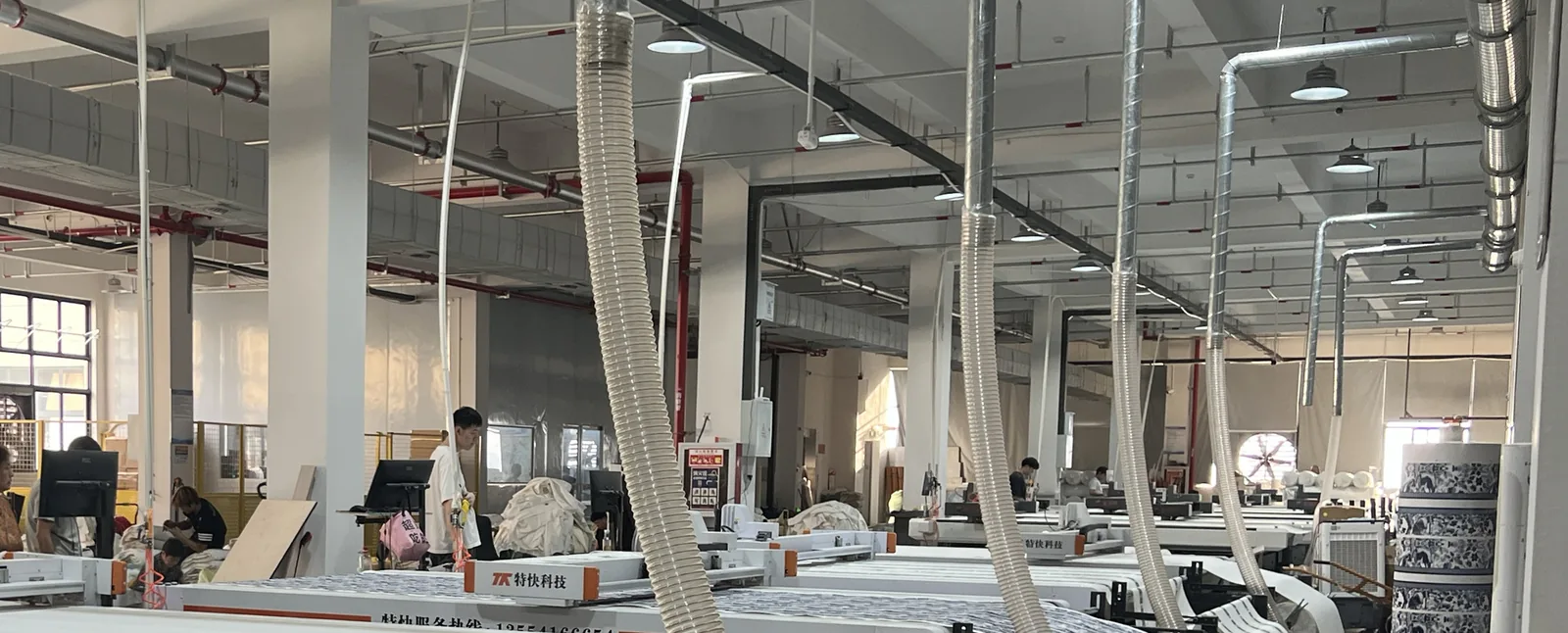 Automated fabric cutting line at the LING YUN straw bag workshop